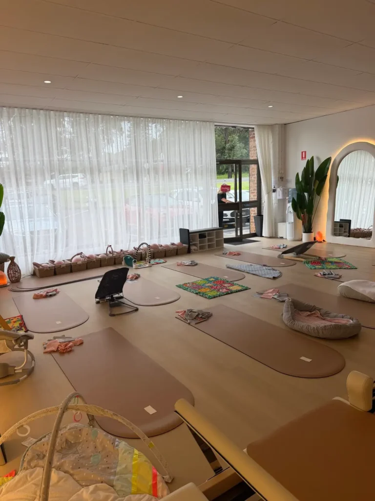 Mum and bub Pilates studio set up with mats, baby play areas and soft natural light